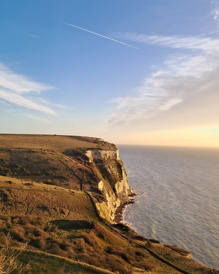 The White Cliffs of Dover glowing gold above the sea