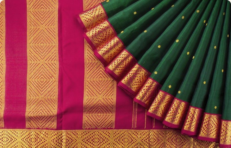 A fanned-out Banarasi saree in green and pink with gold zari
